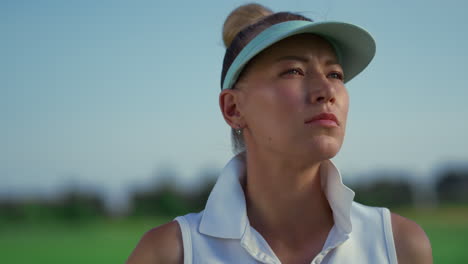 golf player enjoy country club at green course. woman golfer looking sunlight.