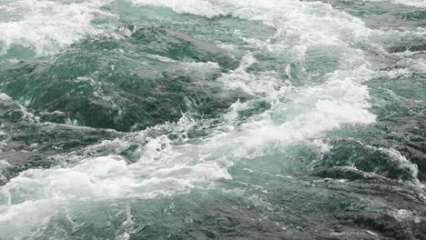 waves of water of the river and the sea meet each other during high tide and low tide.