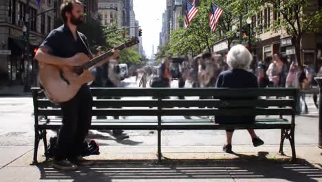 in a bustling city, a street musician captivates passersby with soothing melodies while an elderly woman sits on a bench, soaking in the vibrant atmosphere. people walk by, creating a lively backdrop.
