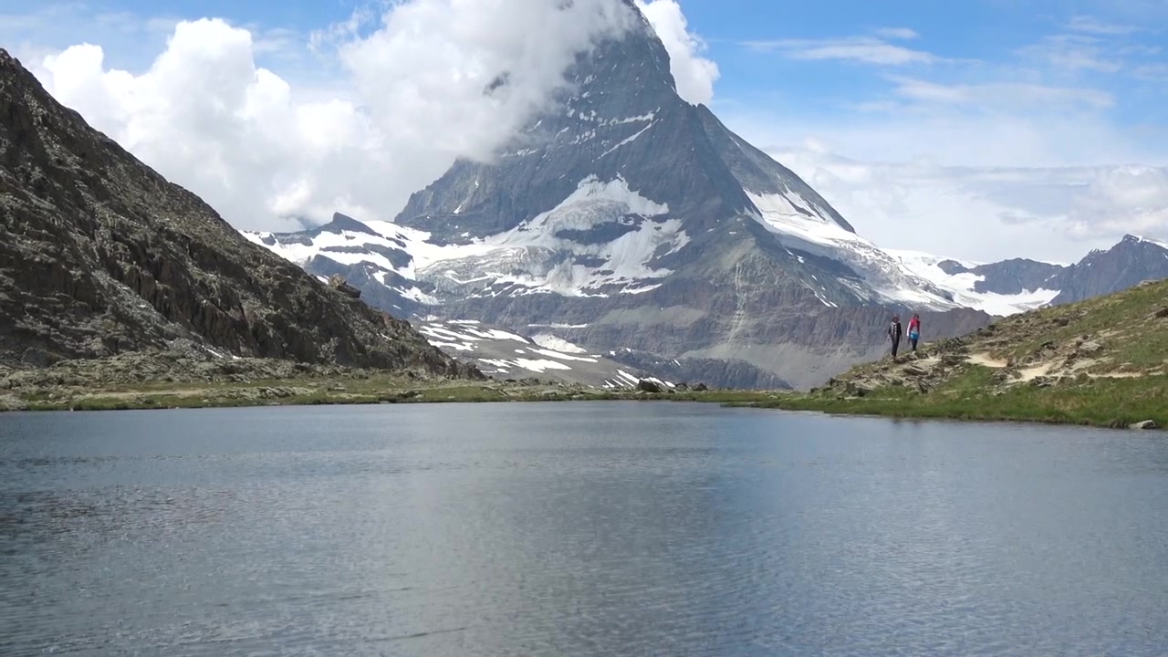 Summer panorama of snowy Matterhorn and tranquil Lake Stellisee near Zermatt