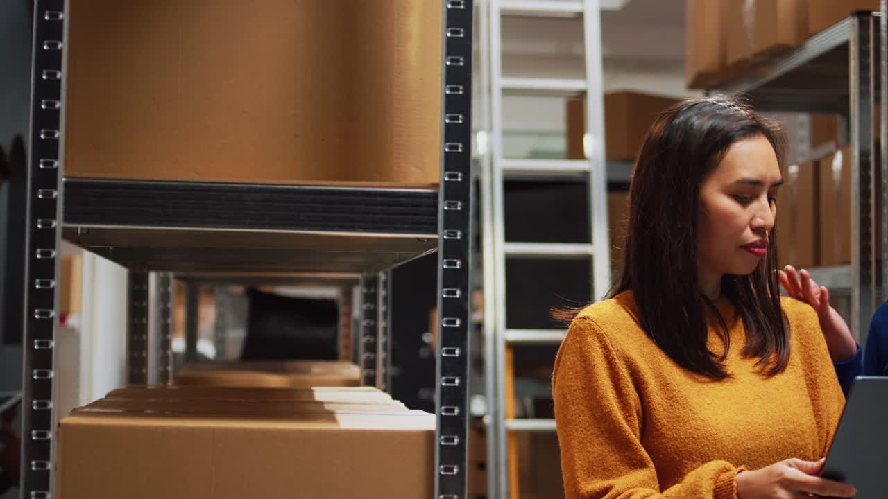 Two Women Using Tablet in Warehouse