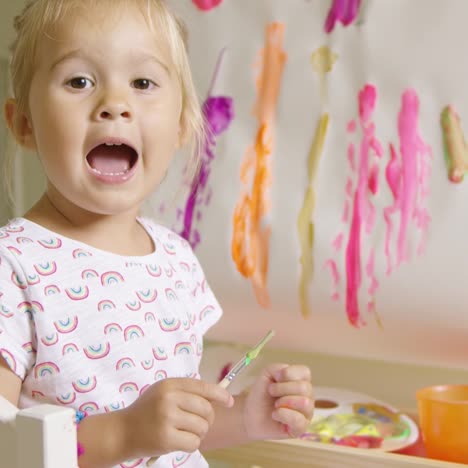 pretty confident little girl painting at home