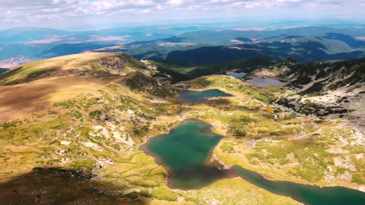 Landscape with lakes, mountains and cloudy sky