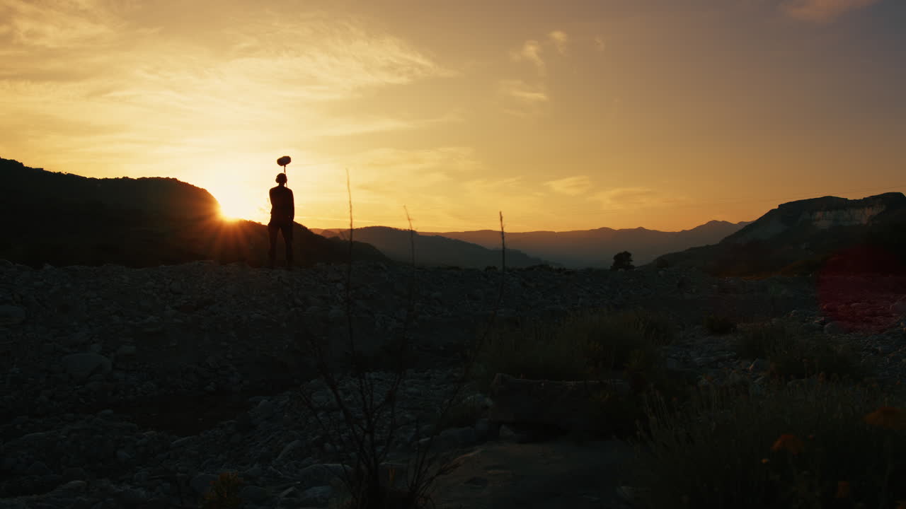 Silhouette Of A Sound Recordist With Boom Is Capturing Background Nature Sound