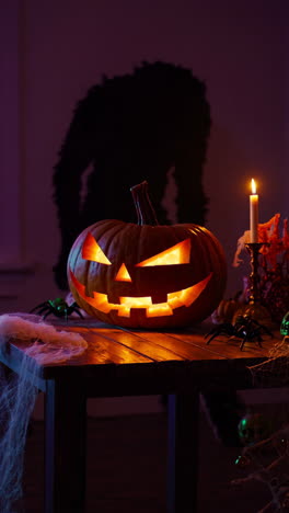 spooky halloween jack-o'-lantern with monster silhouette