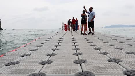 people strolling on a floating pier in krabi