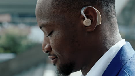close-up of an african american man wearing a hearing aid