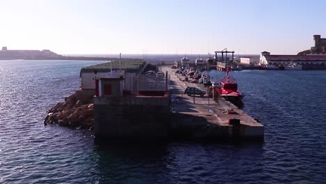 Side-view-of-harbor-from-moving-boat-on-sunny-day-with-blue-sky-in-Morocco