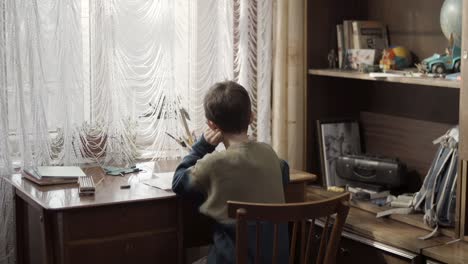 boy doing homework at desk