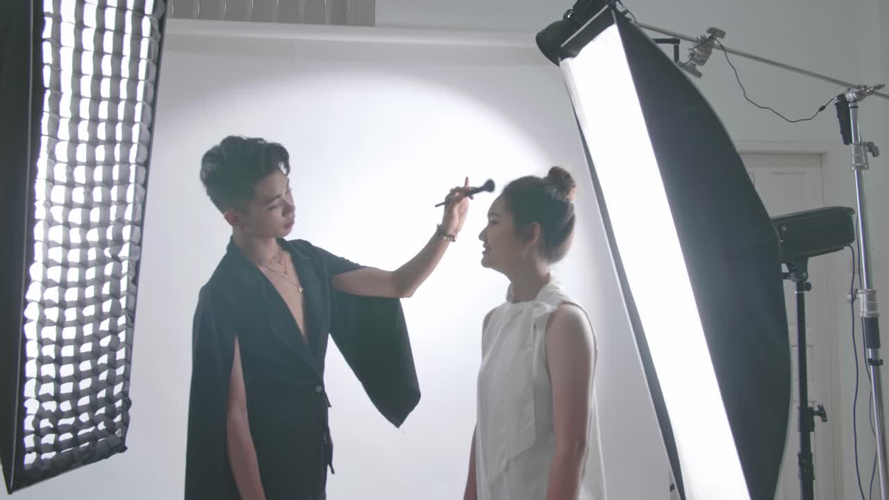 Backstage Of The Photo Shoot: Make-Up Artist Applies Makeup On Beautiful Asian Model