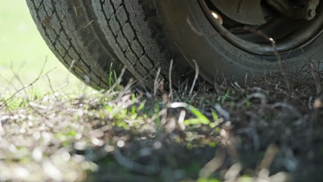 low close up view of two truck tires on grass field - slider right