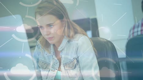 video compuesto digital de la red de iconos de nubes contra mujer caucásica usando computadora portátil