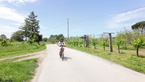 woman cycling through a picturesque italian vineyard