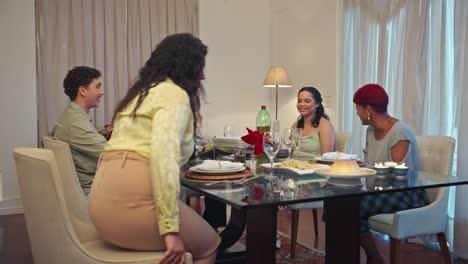 group of people enjoying a meal and conversation at a dining table