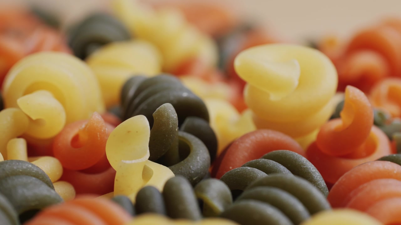 Close-up of Uncooked Tricolor Fusilli Pasta