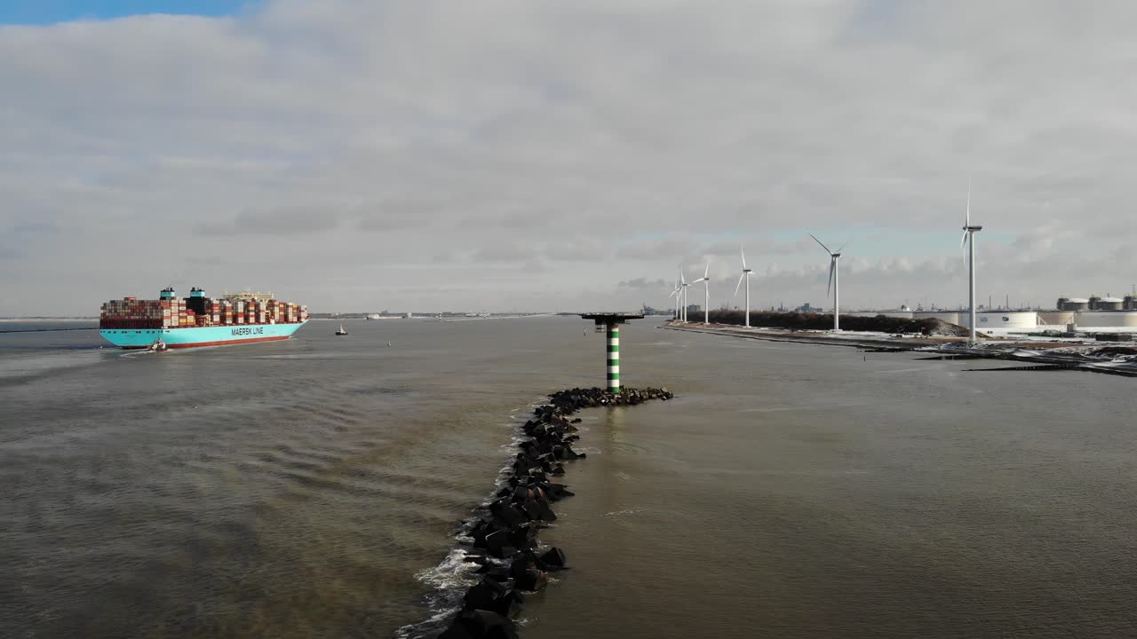 View Of Rotterdam Port In Netherlands With Marstal Maersk Container Ship And Wind Turbines. aerial drone