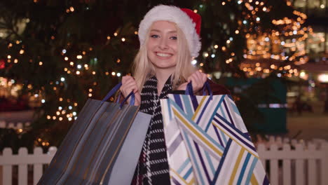 attractive youth holds up her recent purchases from her shopping trip