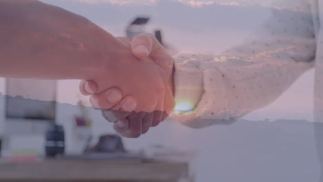 animación de diversos hombres de negocios estrechando la mano sobre el paisaje