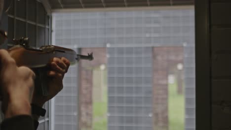 Wide-view-of-rifleman-shooting-the-classic-M1-carbine-on-a-firing-range