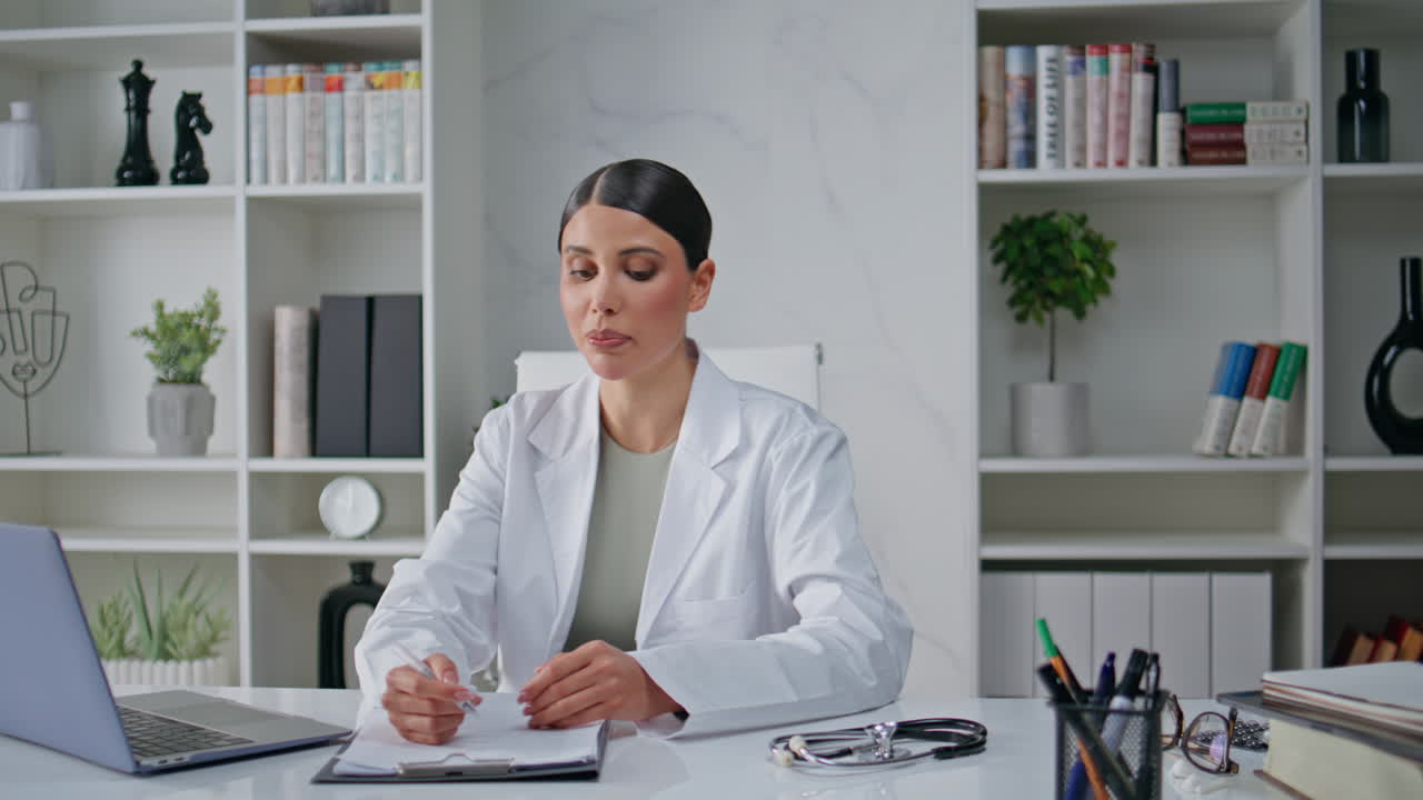Medical consultant talking online call by computer in clinic office closeup