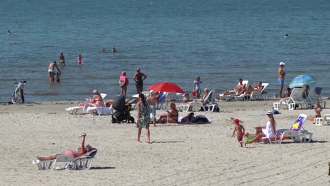 liepaja, latvia august 9. 2020: people relax on the baltic beach in summer. crowd on the beach on weekend vacation