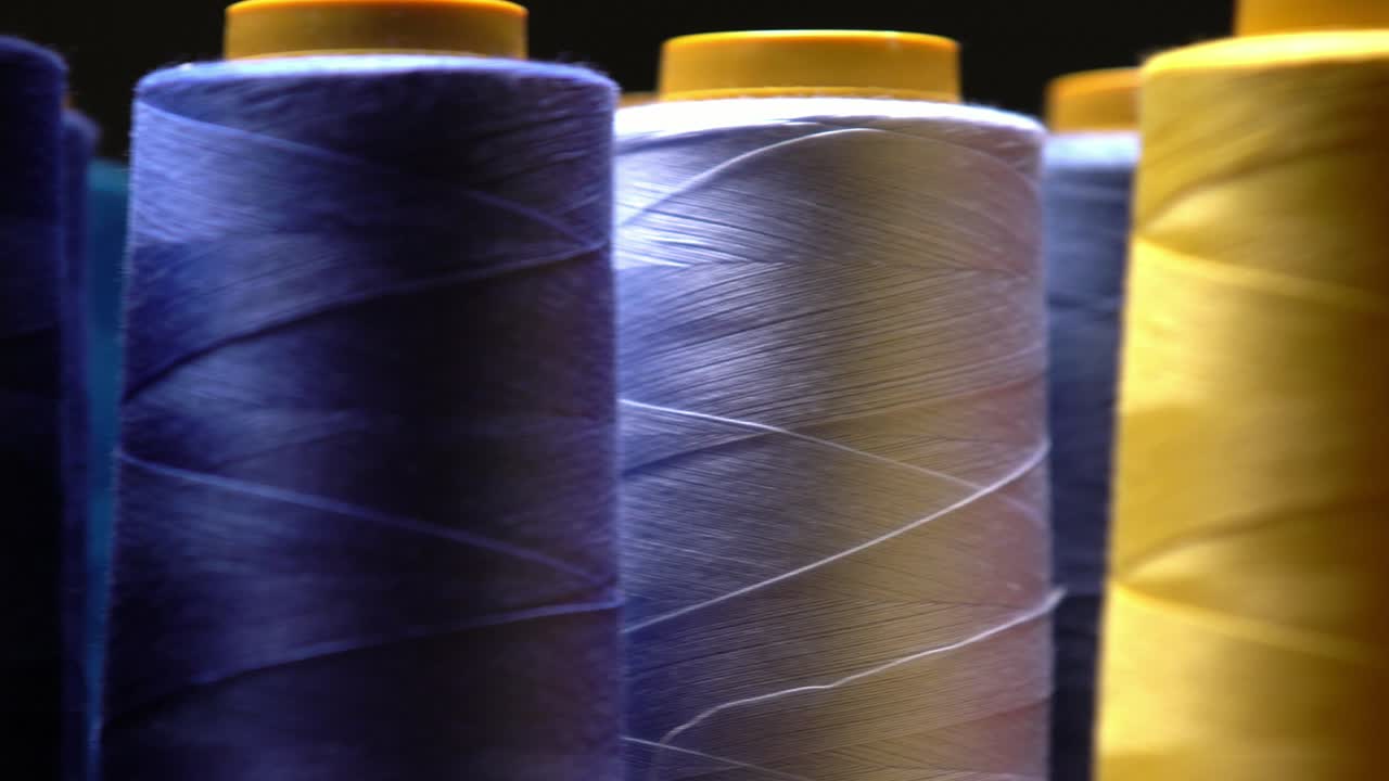 primer plano de hilo de algodón de colores en un taller de fabricación de textiles, industria de la moda de diseño