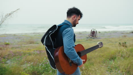 guitarist seeks inspiration with a walk by the sea