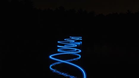 a mesmerizing display of light play on water: captivating waves of blue shimmering reflections create a hypnotic scene under the night sky