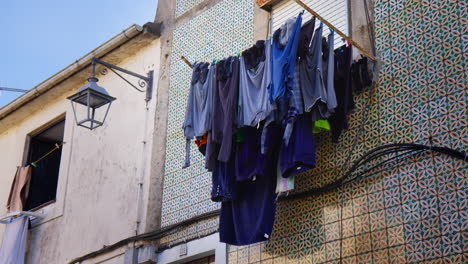 clothes drying outside the typical houses in the old town of porto, portugal. low angle shot