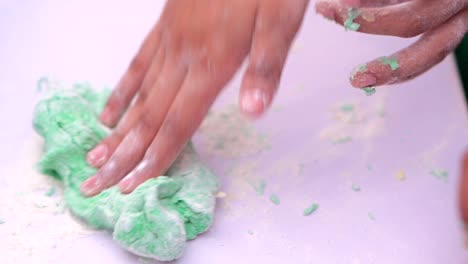 kindergarden kid playing with modeling clay in slowmotion