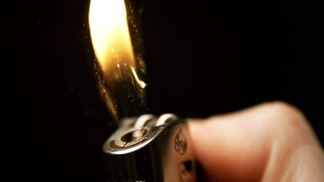 igniting grace: witness the enchanting moment as sparks bloom into flames from a hand holding a lighter, captured in mesmerizing slow motion