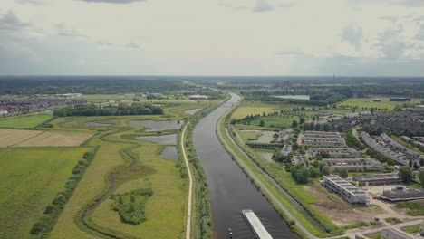 aerial drone view of the epic scene big shipping ship or boat passing at the canal in the netherlands