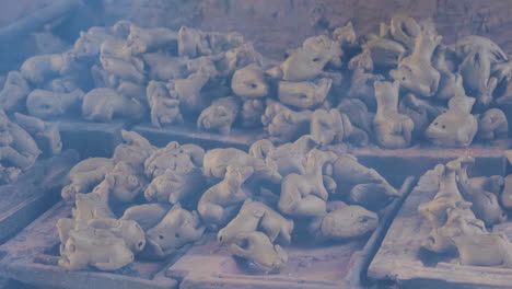 smoky close up of piled clay animal figurines in than ha village vietnam