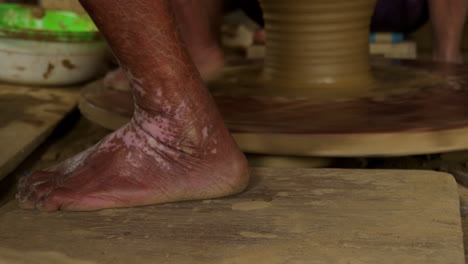 a close-up shot of a foot-powered turning table, showcasing a traditional method of manual labor and craftsmanship