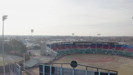 mccoy stadium in pawtucket rhode island, wide drone rising over scoreboard of abandoned baseball field, aerial