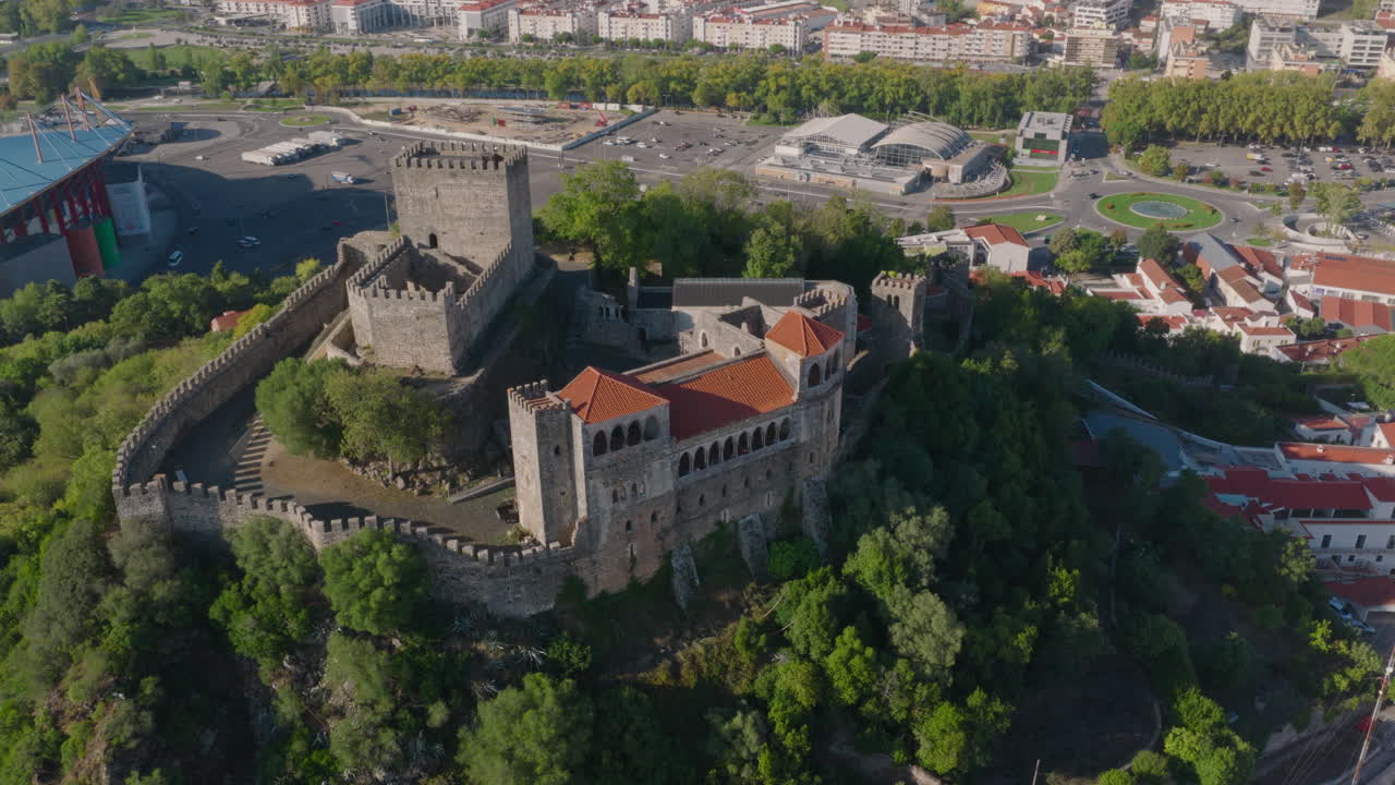 Luftoptagelse i et langsomt, medurs kredsløb af Castelo de Leiria, bred etablerende udsigt over bakketopborg med by nedenfor