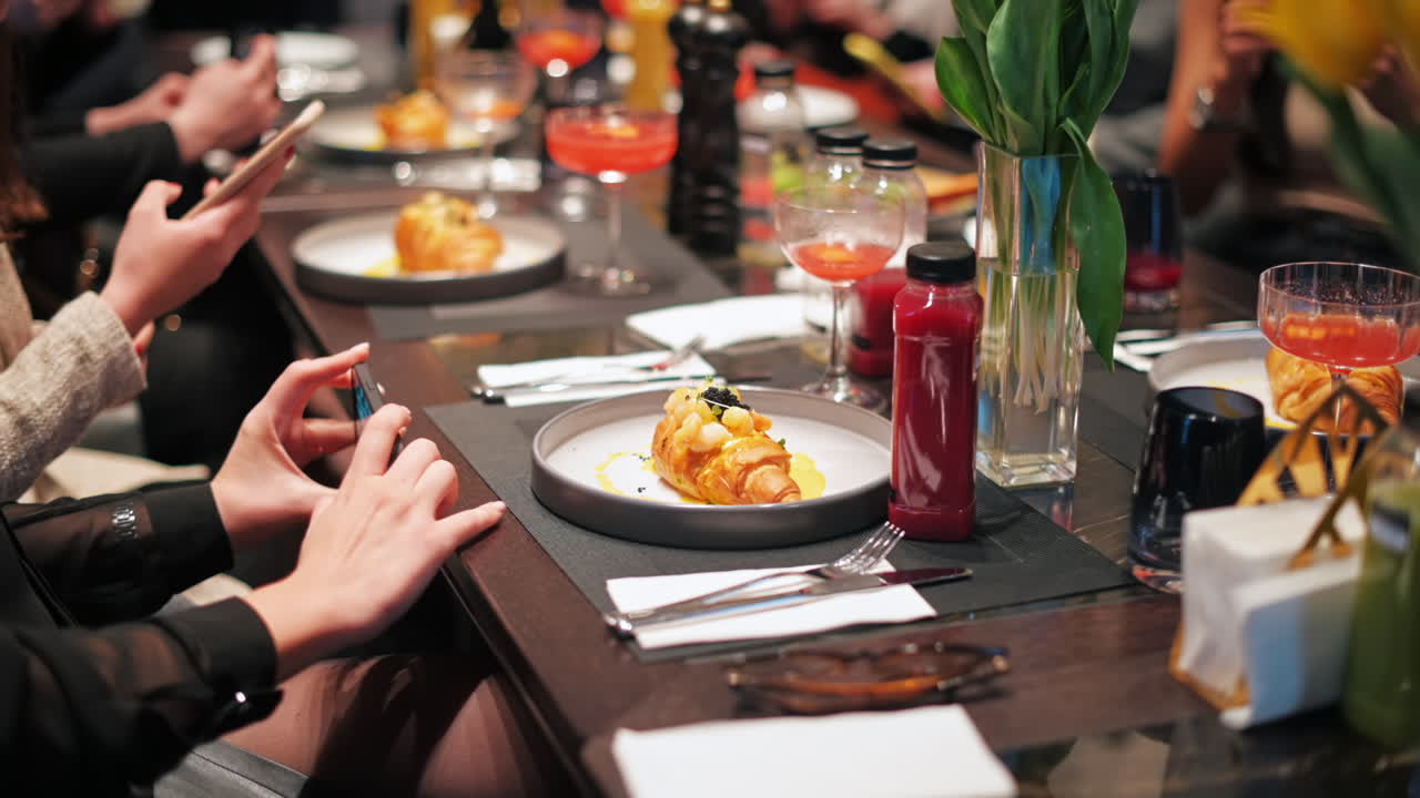 Women trying to shot a dish with food on the social media content production master class