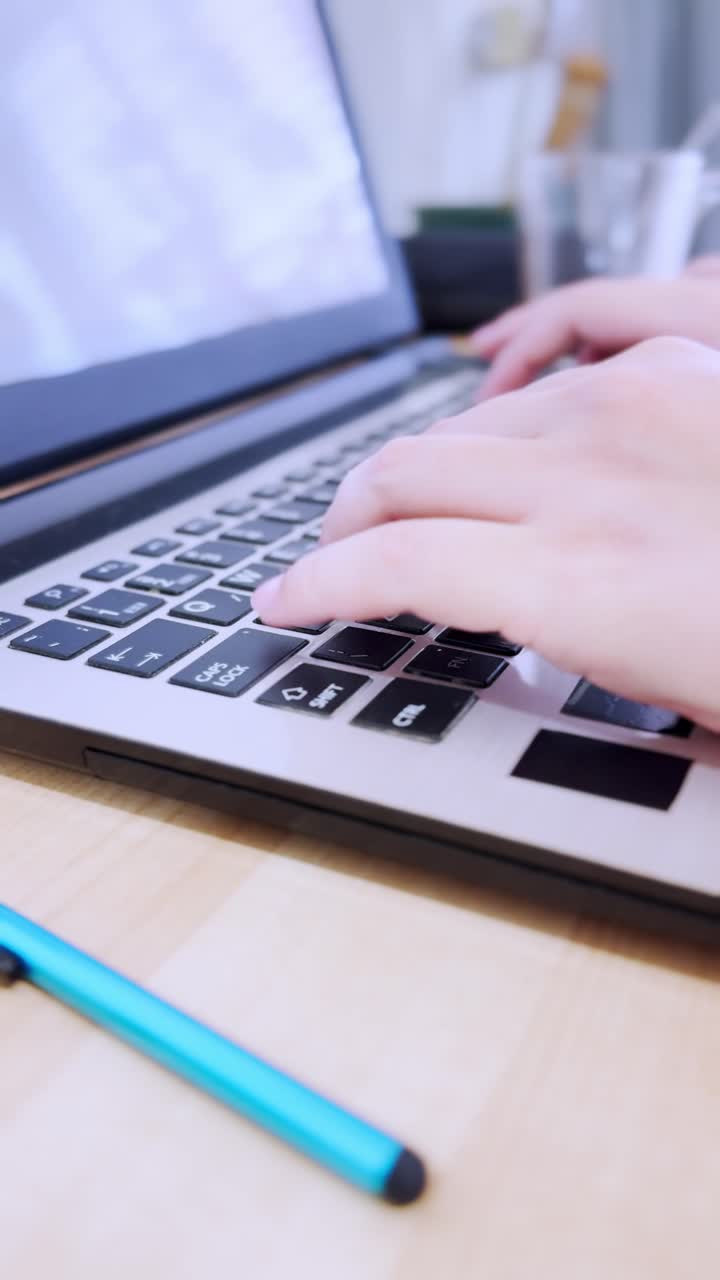 University student hands typing on laptop keyboard