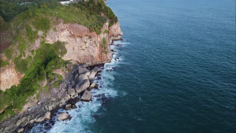 Tropical-Ocean-Cliffs-near-Puncak-Segoro-in-Bali,-Indonesia-Islands---Aerial