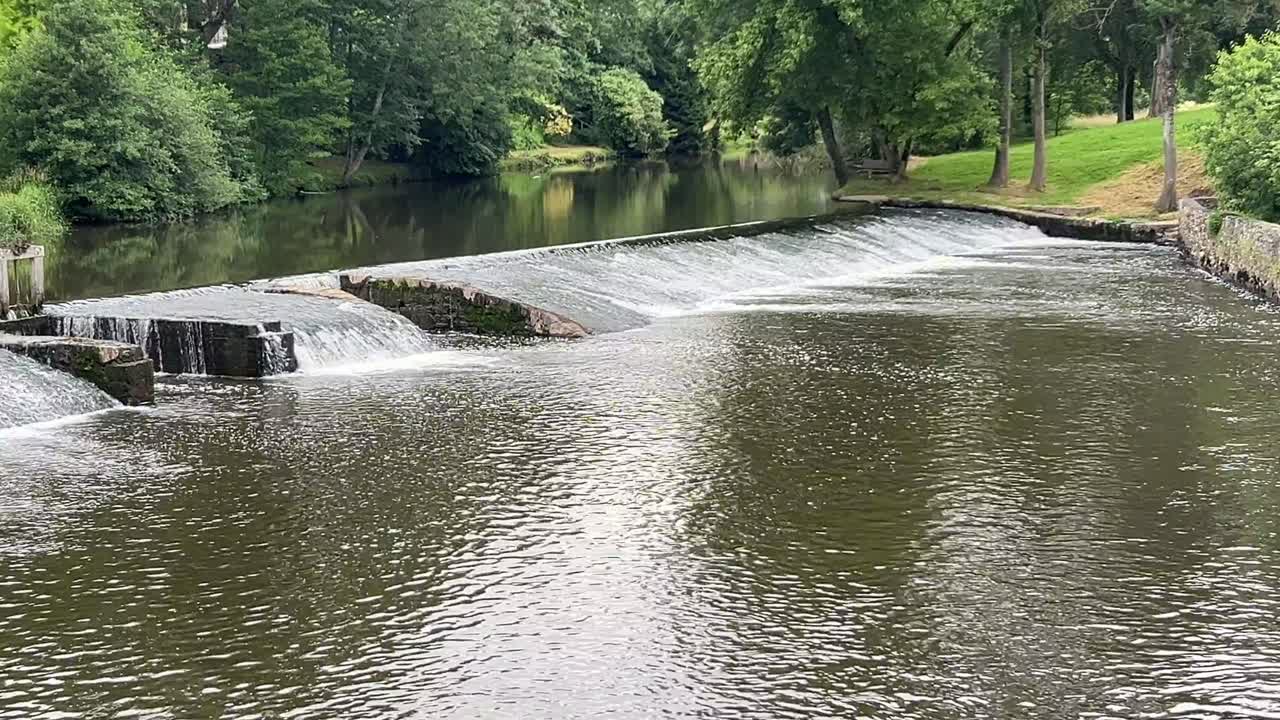 Water flowing over a man made weir for oxygenating the river