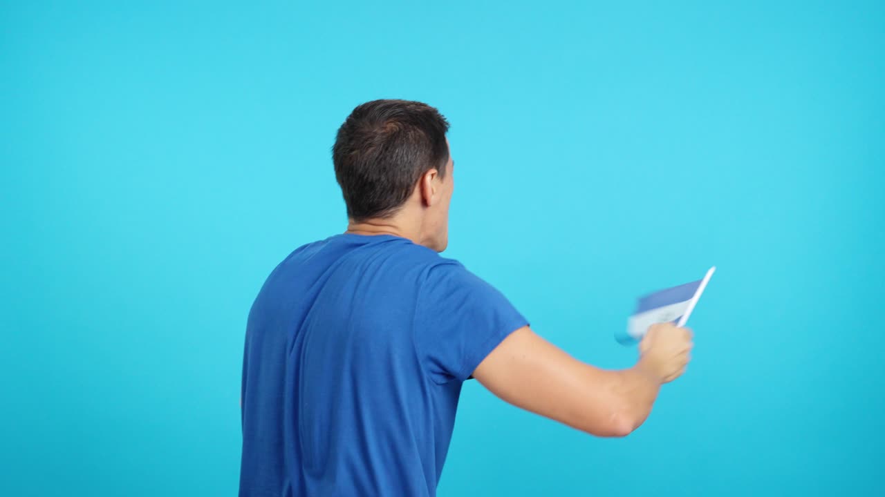 Rear view of a man waving a salvadoran pennant