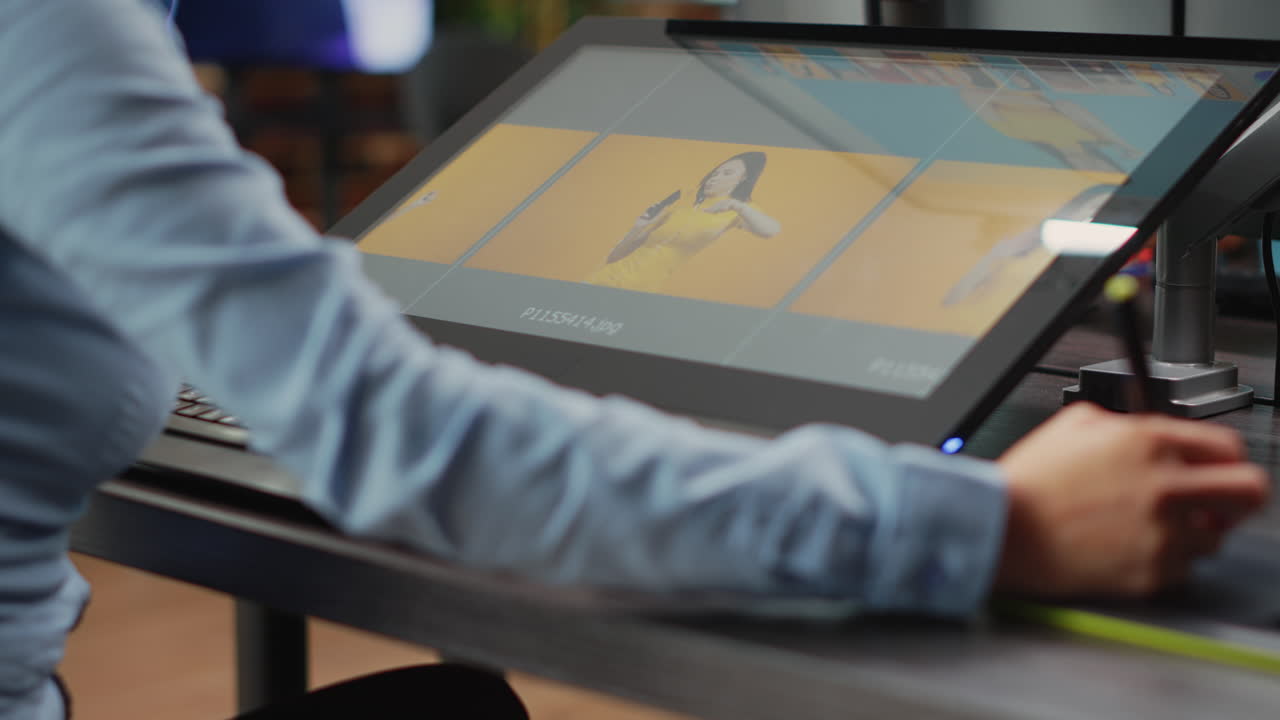 Asian professional artist editing pictures with graphic tablet and stylus