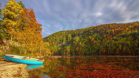 Timelapse-footage-capturing-the-motion-of-clouds-from-a-near-a-blue-boat-docked-at-the-bank-of-Lake-Toplitz