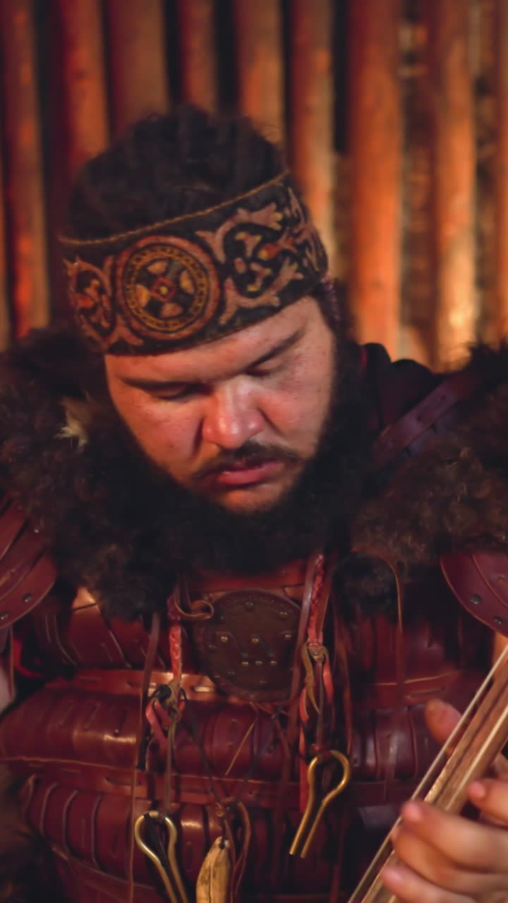 Musician with overweight plays bow instrument during performance in traditional living cabin closeup. Ceremonial sounds of Altai shamans