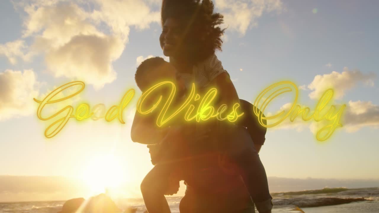 Animation of text vibes over people by seaside
