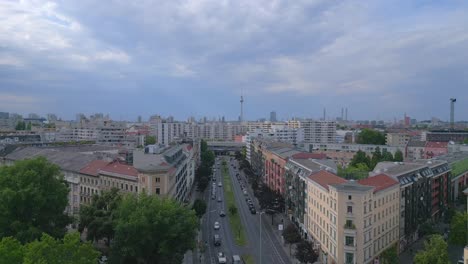 Breathtaking-aerial-top-view-flight-City-Berlin-suburban-railroad-station-prefabricated-building-skyscrapers-district-Neukoeln,-Germany-Summer-day-2023