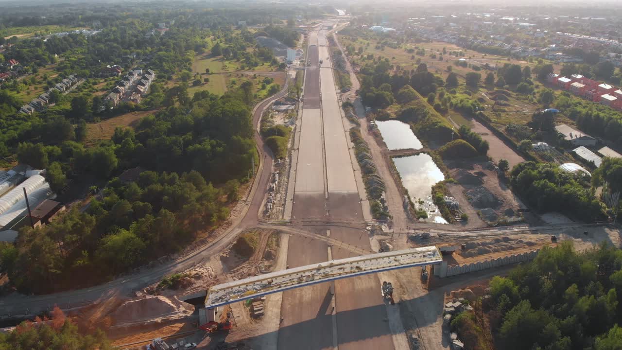 Aerial wide shot on a modern highway construction site near the city