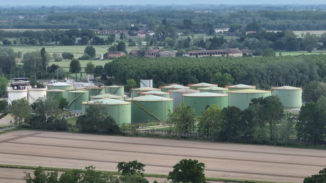 Oil refinery plant at cloudy day.Ecosystem and healthy environment concepts. Lacchiarella, Italy.footage at 50 fps