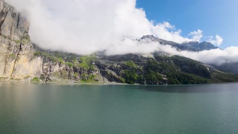 Aerial-flight-over-a-beautiful-big-Oeschinen-lake-on-a-mountain-in-Switzerland