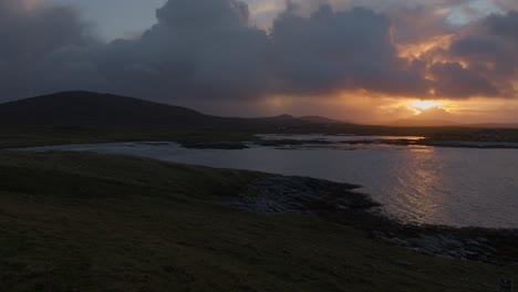 golden hour shot of a winter sunset during a storm over the island of north uist